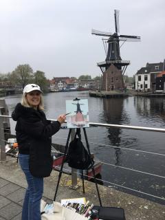 Artist Joyce Frederick painting a windmill